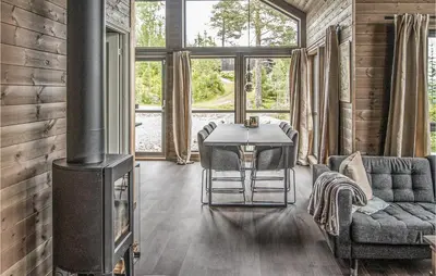 a living room with a stove and a couch at Awesome Home In Rena With Wifi in Rena