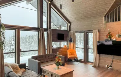 a living room with large windows and a couch at Awesome Home In Rena With Wifi in Rena