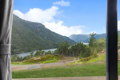 a view of a lake from a window at Sogndal Fjordpanorama - Studio Cabins With View in Sogndal