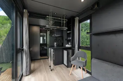 a kitchen and living room in a tiny house at Sogndal Fjordpanorama - Studio Cabins With View in Sogndal