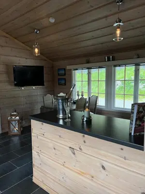 a kitchen with a bar in a log cabin at Beitostølen sentralro in Beitostøl