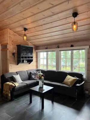 a living room with a couch and a table at Beitostølen sentralro in Beitostøl