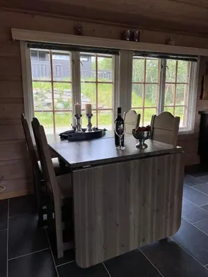 a large island in a kitchen with a table and chairs at Beitostølen sentralro in Beitostøl