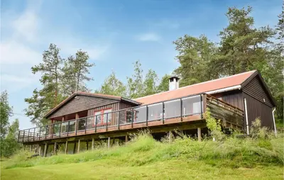 a house on top of a grassy hill at 3 Bedroom Stunning Home In Vossestrand in Vossestrand