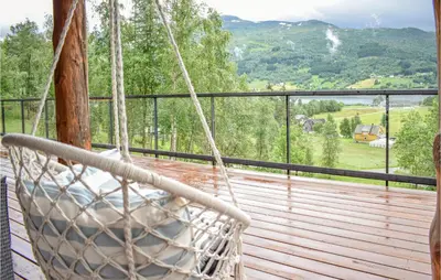 a porch with a hammock on a deck with a view at 3 Bedroom Stunning Home In Vossestrand in Vossestrand