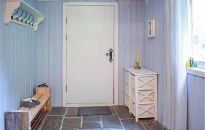 a white door in a blue room with a table at 3 Bedroom Stunning Home In Vossestrand in Vossestrand