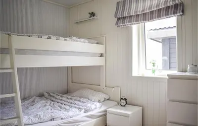 a small bedroom with a bunk bed and a window at Nice Home In Sveio With House Sea View in Sveio