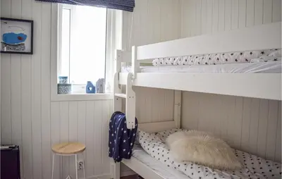 two bunk beds in a room with a window at Nice Home In Sveio With House Sea View in Sveio