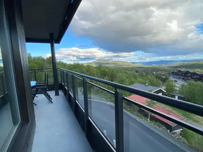 a balcony with a view of the mountains at Riddertunets moderne in Beitostøl