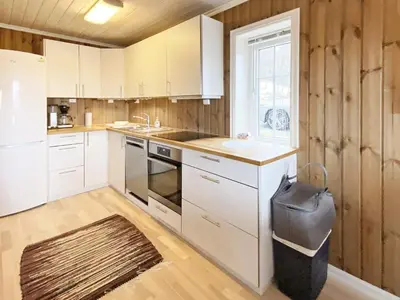 a kitchen with white cabinets and a sink and a window at 5 person holiday home in Rauland-By Traum in Rauland