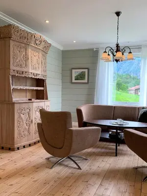 a dining room with a table and chairs at Nesje Gardstun in Oppstryn