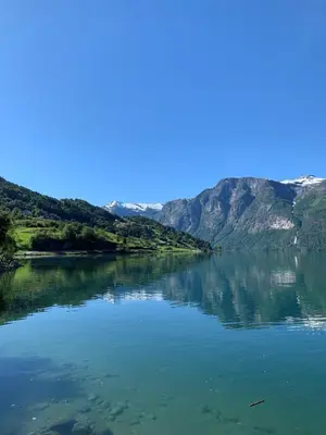 a view of a lake with mountains in the background at Nesje Gardstun in Oppstryn