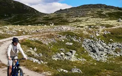 a person riding a bike on a dirt road at Mountain retreat in Uvdal WIFI SAUNA in Uvdal