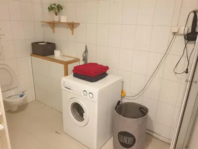 a washing machine in a bathroom with a trash can at Holiday Home in Gol