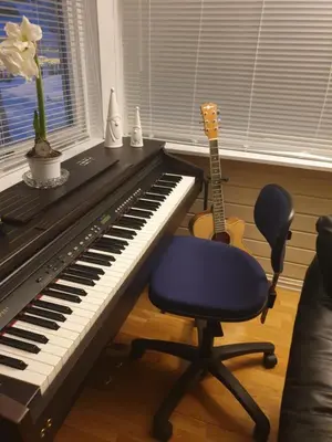a desk with a piano and a chair and a guitar at Holiday Home in Gol