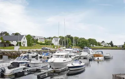 a bunch of boats are docked in a harbor at 4 Bedroom Gorgeous Home In Herdla in Herlø