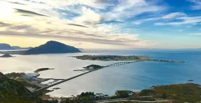an island with a bridge in the water at Ytterland Apartments in Ålesund