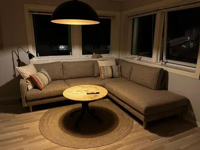 a living room with a couch and a table at Ytterland Apartments in Ålesund