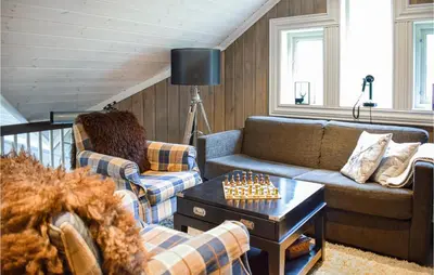 a living room with a couch and a chess board at Lovely Home In Vossestrand With Wifi in Vossestrand