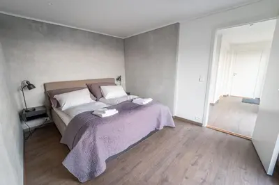 a bedroom with a bed with a purple blanket at Runde Panorama - Ørneredet in Runde