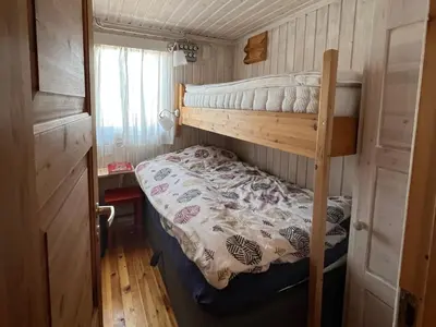 a bedroom with a bunk bed in a tiny house at Beitos hjemmekoselige in Beitostøl