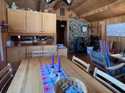 a dining room with a wooden table and chairs at Beitos hjemmekoselige in Beitostøl