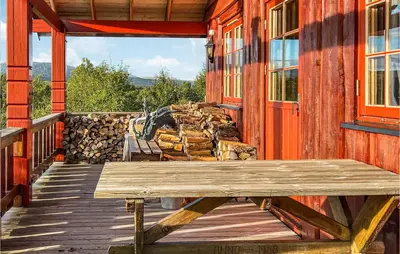 a wooden porch with a wooden bench on a house at Nice Home In Hovden I Setesdalen in Hovden