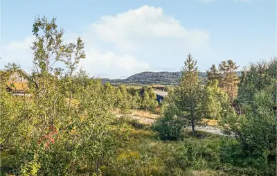a view of trees and a bridge in the distance at Nice Home In Hovden I Setesdalen in Hovden