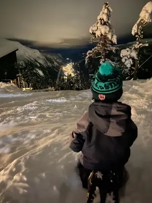 a child is standing in the snow at New apartment, Gausta in Rjukan. Ski in/ ski out in Rjukan