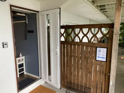 an open door to a porch with a gate at Great place with a stunning view of the mountains and the fjord in Ålesund