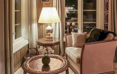 a living room with a chair and a table and a lamp at Lovely Home In Tuddal With Jacuzzi in Tuddal
