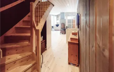 a hallway with wooden stairs in a house at Lovely Home In Tuddal With Jacuzzi in Tuddal