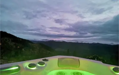 a bath tub with a view of the mountains at Lovely Home In Tuddal With Jacuzzi in Tuddal