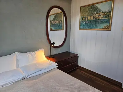 a bedroom with a bed and a mirror at Sigurd's Loft in Vossevangen