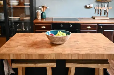 a bowl of fruit sitting on a wooden table in a kitchen at Sigurd's Loft in Vossevangen