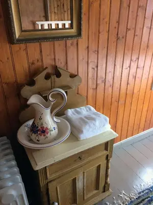 a table with a vase on it next to a mirror at Overvoll Farm in Stranda