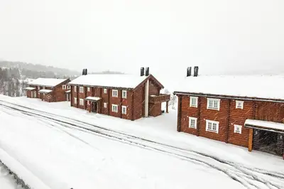 a row of buildings covered in snow at Lake View Apartment 4 bedrooms and 2 bathrooms in Sykkylven