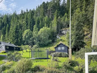 a basketball hoop in a field with a house at 4 person holiday home in Bryggja-By Traum in Bryggja