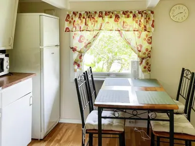 a kitchen with a table and chairs and a window at 4 person holiday home in Bryggja-By Traum in Bryggja