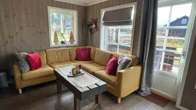 a living room with a couch and a coffee table at Sanderstølen Hytte in Tisleidalen