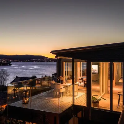 a glass house with a view of the water at 