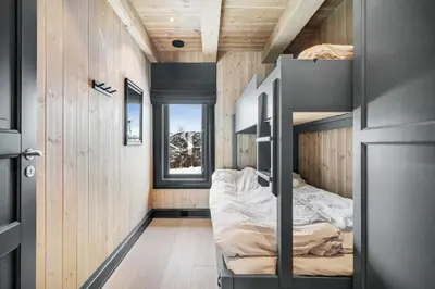 a bedroom with bunk beds in a tiny house at NEW LUXUARY Cabin with perfect location on Geilo. in Flatåker