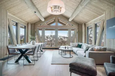a living room with a couch and a table at NEW LUXUARY Cabin with perfect location on Geilo. in Flatåker