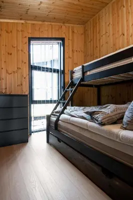 a bedroom with two bunk beds and a window at Gaustablikk Hytte - MountainView in Gaustablikk