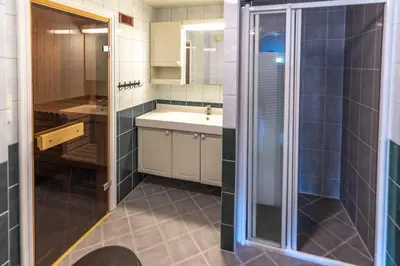 a bathroom with a sink and a shower at Bakkebyvegen 1D in Trysil