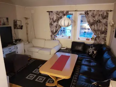 a living room with a couch and a coffee table at Ålesund Apartment with free parking in Ålesund