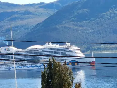 a cruise ship is docked in the water at Ålesund Apartment with free parking in Ålesund