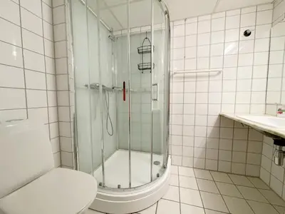 a white bathroom with a shower and a toilet at Actif 329 - apartment by Ål skisenter in Ål