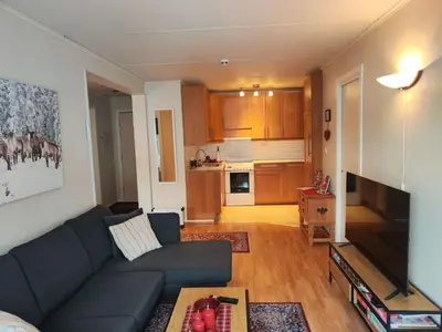 a living room with a couch and a kitchen at Actif 329 - apartment by Ål skisenter in Ål