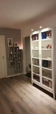 a living room with a large white book shelf at Sentralt 10 minutt med buss til Trondheim Sentrum in Trondheim
